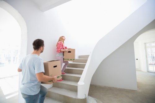 Professional movers in Andstorage handling furniture during a house relocation